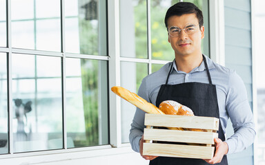 Caucasian handsome male bakery business owner or entrepreneur wearing eyeglasses, smiling with...