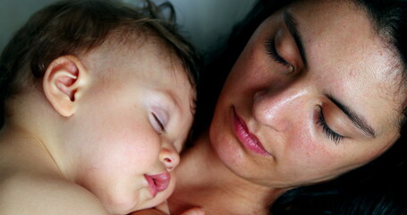 Mother and baby sleeping napping together. Casual mom and infant child asleep nap