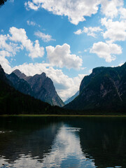 reflections in an italian lake in the alps