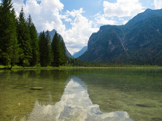 reflections in an italian lake in the alps