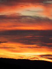 a wonderful orange sunset with the sea and land in the background