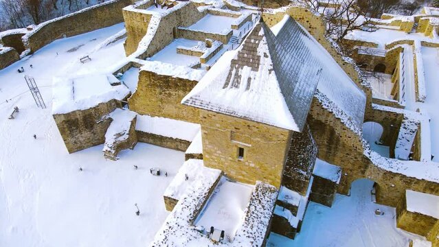 Birds eye view over Citadel of Suceava, Romania in winter season. Footage was shot from a drone at a higher altitude.