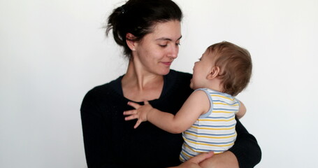 Cute casual mother baby relationship showing love and affection with kisses and hug