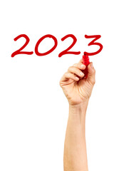 Hand of woman writing the number 2023. New year concept