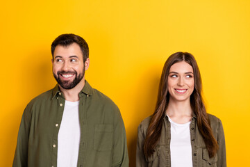 Portrait of two minded cheerful partners look empty space imagine isolated on yellow color background - obrazy, fototapety, plakaty