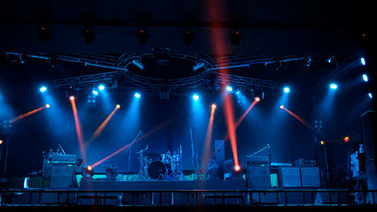 Stage lighting beams spotlight and smoke of events show or concerts