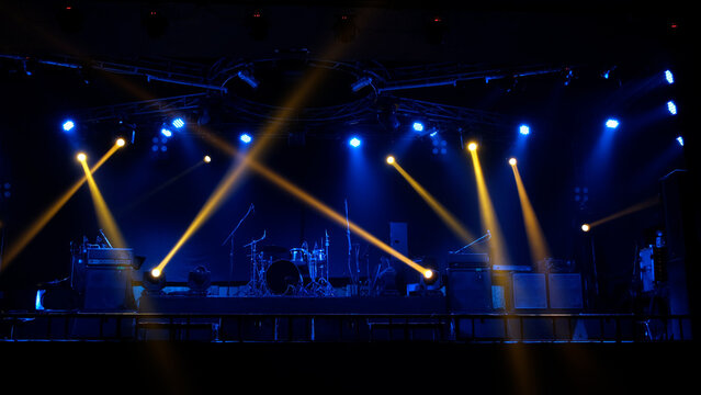 Stage lighting beams spotlight and smoke of events show or concerts