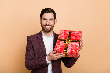 Photo of young positive mam receive birthday present from colleagues isolated on beige color background