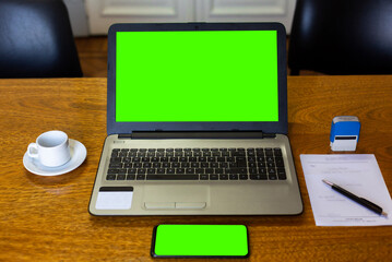Close up view of doctor's office laptop with mock up green screen browsing internet at work desk....