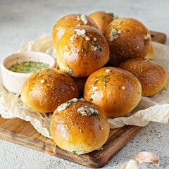 Freshly baked buns (pampushki) with garlic and dill for the first course (soup) on a baking tray. National Ukrainian dish, food. Selective focus.