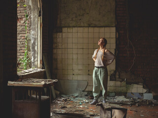 Woman inside an ancient ruined building. Old littered broken room. Walk through the old ruins. House destroyed by war - 530861688
