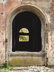 Arched windows in a crumbling abandoned old building. Abandoned city.