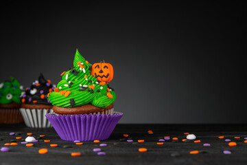 Cupcake on Halloween. Pumpkin Jack o lantern. Dessert on Halloween party. Muffin decorated with...