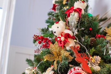 Beautiful Christmas decorations in the shape of a bear, hanging on the Christmas tree. Home Decoration for Christmas.soft toy in the New Year's interior