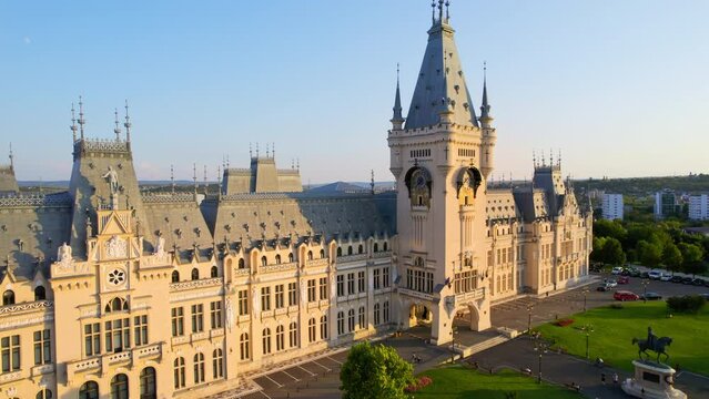 Aerial drone view of the Palace of Culture in Iasi downtown at sunset, Romania. Square with Stephen the Great statue, people and greenery in front of it, buildings around
