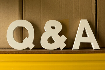 Question and answers concept. Wooden alphabet of letter q and a.