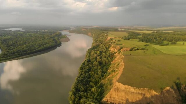 Aerial view of big siberian Ob river, river bank in beauty summer evening, 4K drone footage.