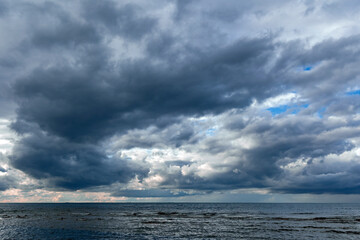 	
Dramatic stormy dark cloudy sky over Baltic sea just before a sea storm in Riga, Latvia. Nature environment concept. Gloomy and moody background.