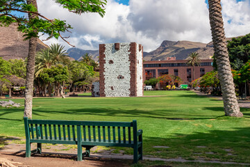 Fototapeta premium Panoramic view on the tower Torre del conde at the island capital San Sebastian de La Gomera, La Gomera, Canary Islands, Spain, Europe. Bench in the foreground. Tourist attraction in town centre