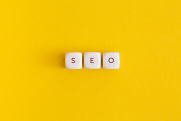 The word seo on yellow background.  Top view. Flat lay.