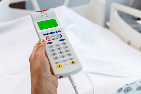Nurse call button in patient room in modern hospital. Hand pushing nurse call button. patient press red emergency button to calling nurse for help in hospital