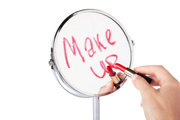 Female hand with red lipstick writes Make up on mirror. Inscription Make up on facial mirror. Desktop make up cosmetic mirror isolated. Home metal mirror close up isolated