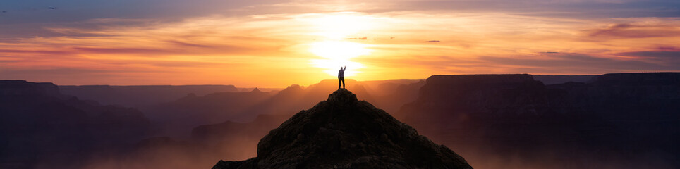 Epic Adventure Composite of Man Hiker on top of a rocky mountain. Dramatic Sunset Sky. 3d Rendering peak. Background landscape from North America. Freedom Concept.