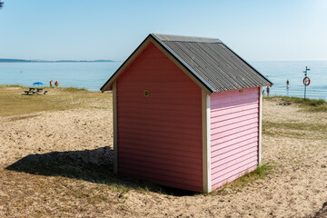 Fototapeta na wymiar Little cozy tiny wooden multicolored houses on a beach in Sweden. Sunny summer day.