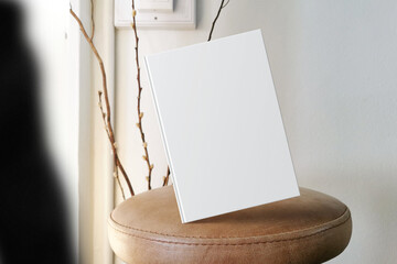 Clean minimal book 4x6 mockup floating on leather seat with lamp