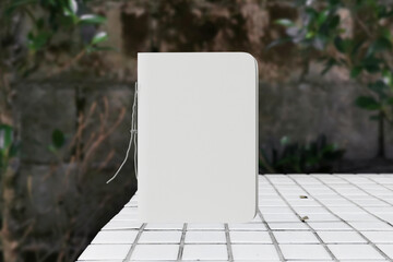 Clean minimal cover notepads mockup standing on top tiled bench