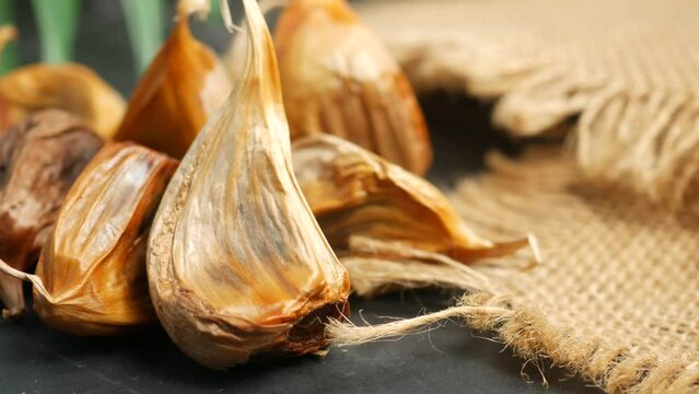 close up pf black garlic on white background table 
