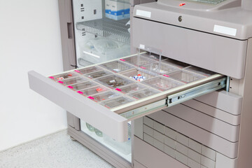 pharmacist selects medicine from hospital medicine automation system by scanning her finger. Pyxis...