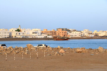 Fototapeta na wymiar March 21 2022 - Sur, Oman: People come together at the harbor in the bay of Sur