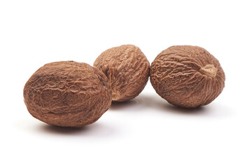 Fresh Nutmeg. Whole nuts, close-up, isolated on white background.