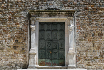 Entrance portal of the Pieve of Saint Andrew (10th c.), an ancient Romanesque parish church in the...
