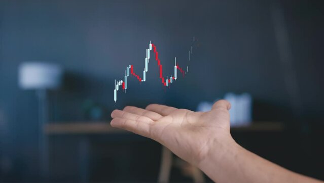 Apeared hand shows stockmarket chart animated as hologram candlessticks graph, futuristic concept of stock trading