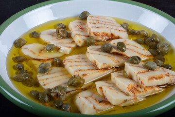 Cheese marinated in olive oil with fresh herbs in glass jar. High quality photo