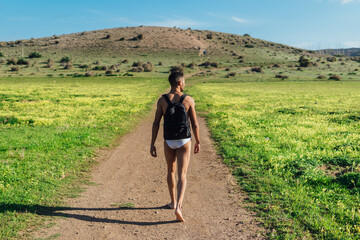 Man in underpants walking on road in highlands