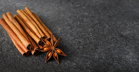 Cinnamon sticks and star anise on a dark gray background