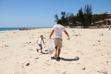 Father and Daugher Cleaning Beach