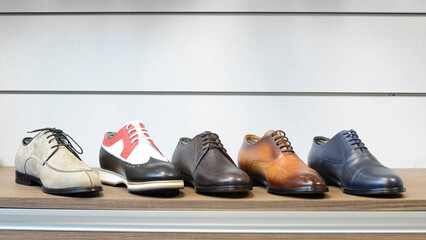 casual classic men's shoes in different colors and models on the stand