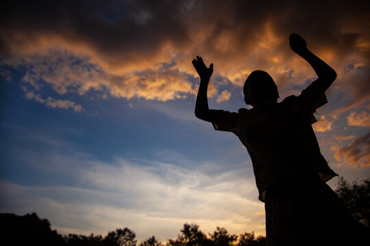 Silhouette of a child at sunset in Kitgum, Northern Uganda, Africa.