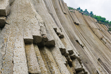 basalt columns forming a coastal rock at Cape Stolbchaty on Kunashir Island, close-up