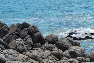 rocky seashore, gray basalt cliffs on the shore
