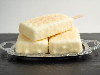 Orange ice cream with white milk chocolate.