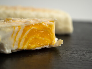 Orange ice cream with white milk chocolate.