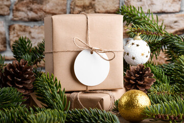 Blank round Christmas gift tag mockup with present box, product label mockup, with natural fir tree...