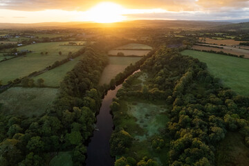 Fototapeta na wymiar Scenic sunrise over river and farmland in north county Kerry, Ireland.