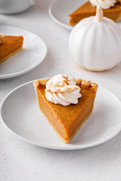 Slices of traditional pumpkin pie in a light and bright setting