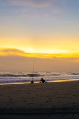 A fisherman is fishing with a fishing rod on the ocean, Bali, Indonesia.